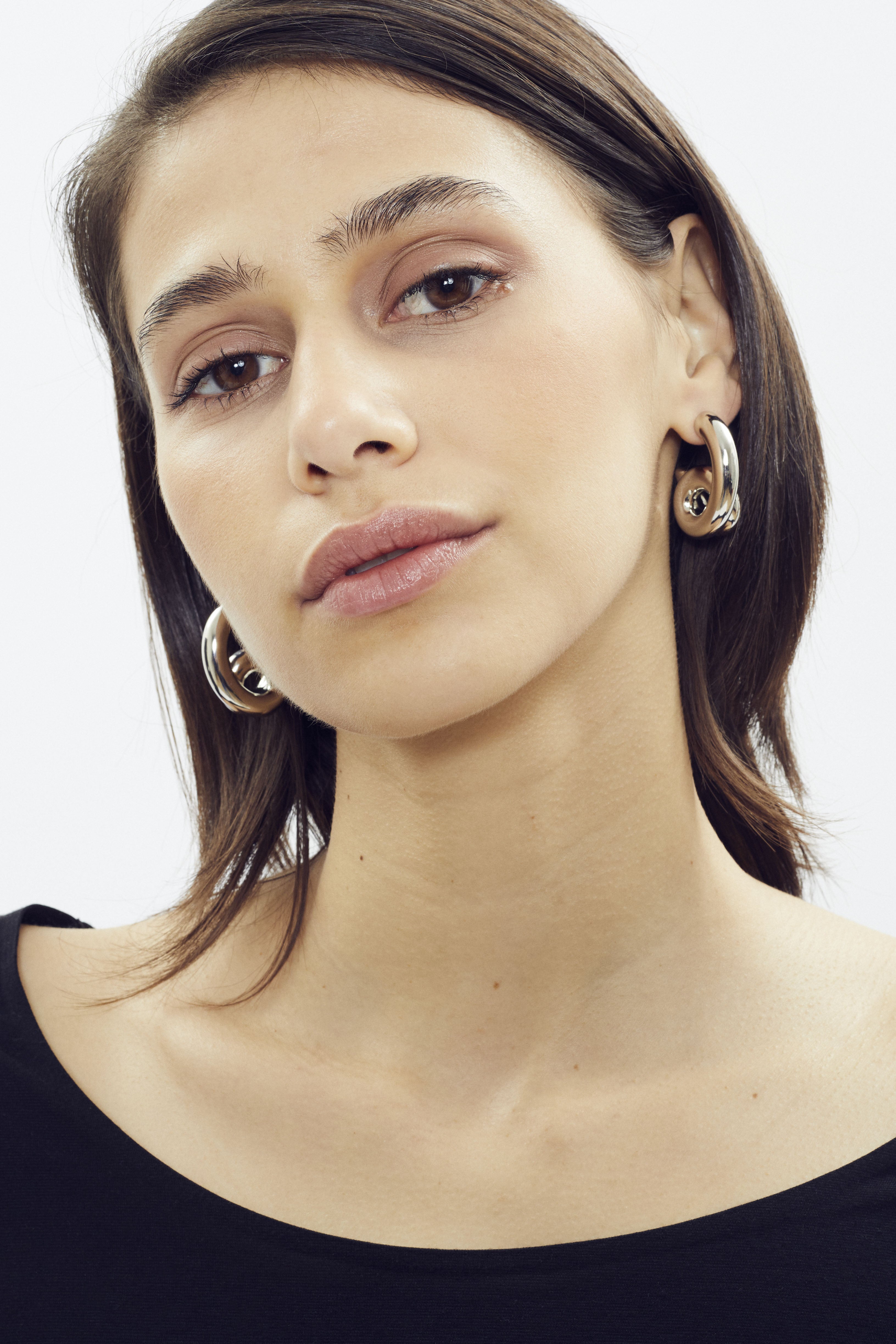 Sculptural hoop earring in platinum finish by SONNEY, shaped like a coiled tube