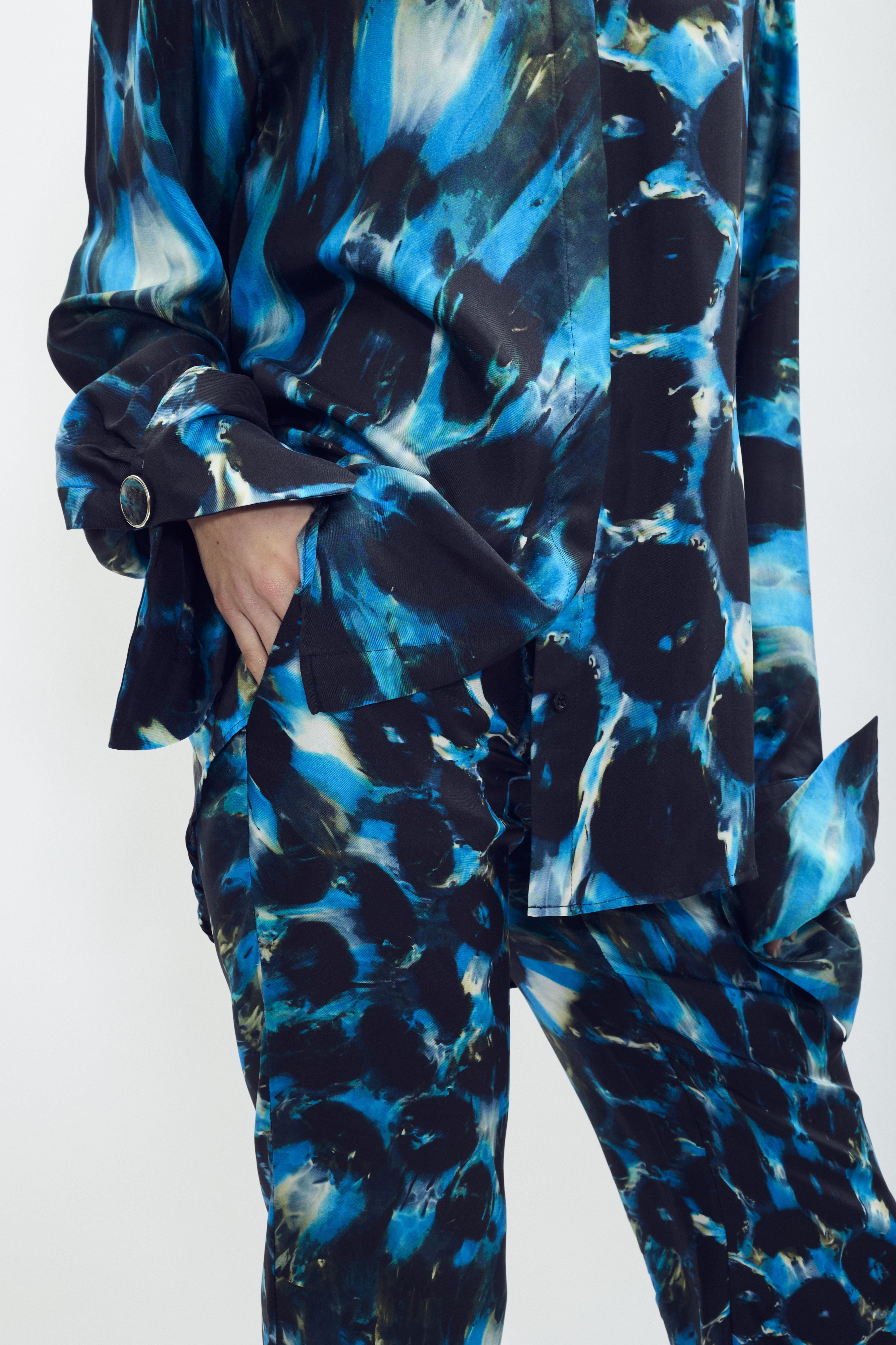 Silk shirt with SONNEY’s signature print and green accents, flowing oversized fit